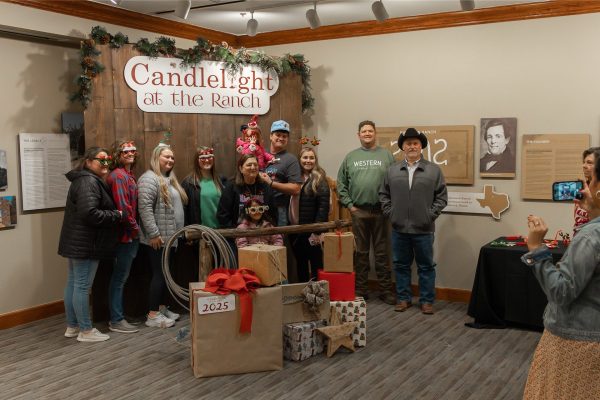 A big family group taking photos at the photo booth.