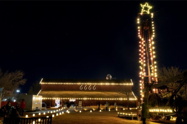 The Four Sixes barn and old oil spudder lit with Christmas lights.