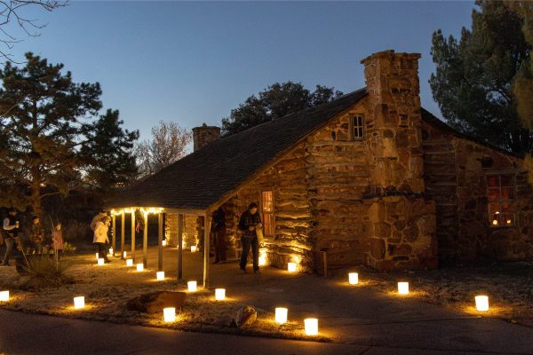 Hedwig's Hill dogtrot house from the 1800s with pathways lit by luminaries.